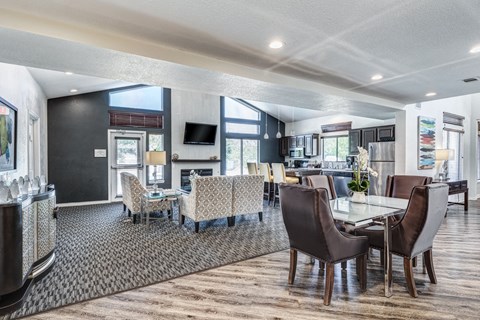 a living room and dining room with a table and chairs
